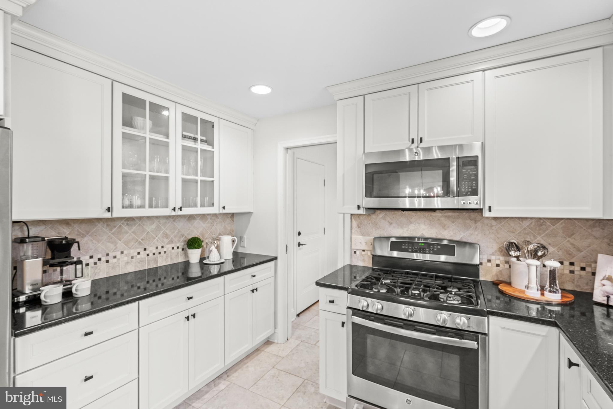 124 Deepdale Road Wayne, PA 19087 - Photo 15 of 35 a kitchen with granite countertop white cabinets and stainless steel appliances