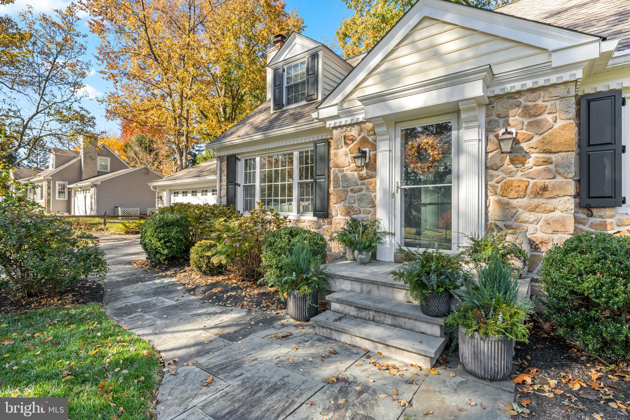 124 Deepdale Road Wayne, PA 19087 - Photo 4 of 35 a view of a brick house with potted plants