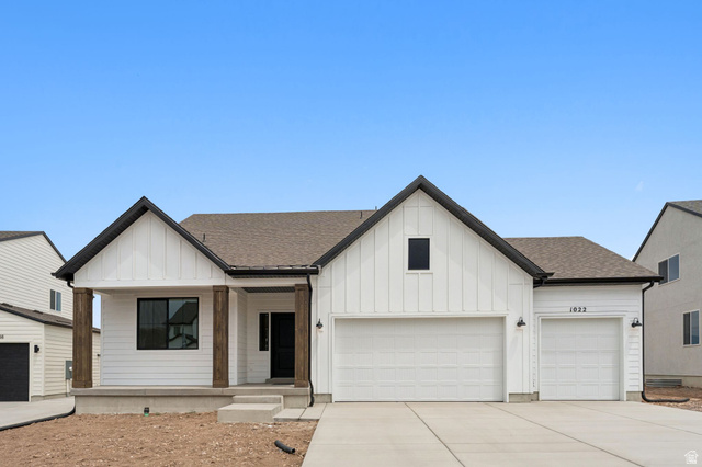 1004 West Paramount Cove South, Unit 315 Ogden, UT 84405 - Photo 3 of 42 Modern farmhouse exterior featuring white board and batten siding, dark trim accents, and a covered porch with wood wrapped columns