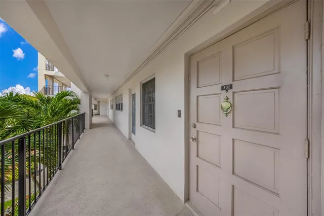 a hallway with wooden floor and windows
