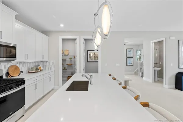 a large white kitchen with a large window