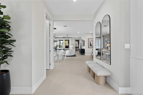 a living room with furniture and a potted plant