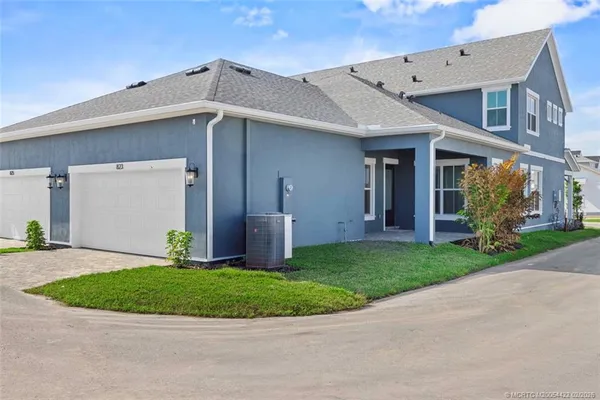 a kitchen with a sink a refrigerator and cabinets