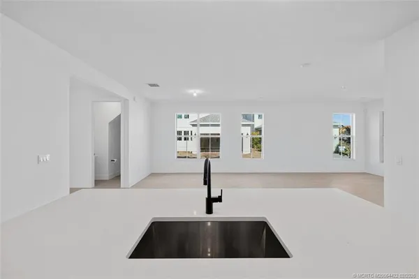 a kitchen with stainless steel appliances a sink stove and refrigerator