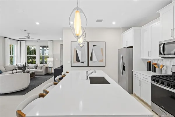 a large kitchen with a table and chairs