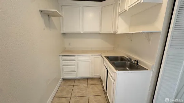a kitchen with a sink and cabinets