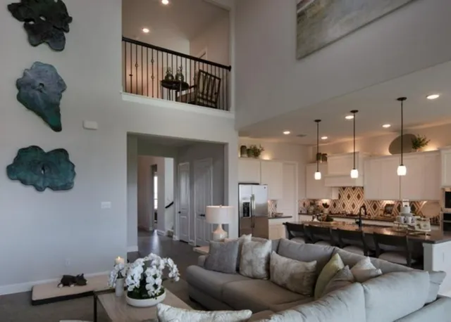 a living room with furniture and a view of kitchen