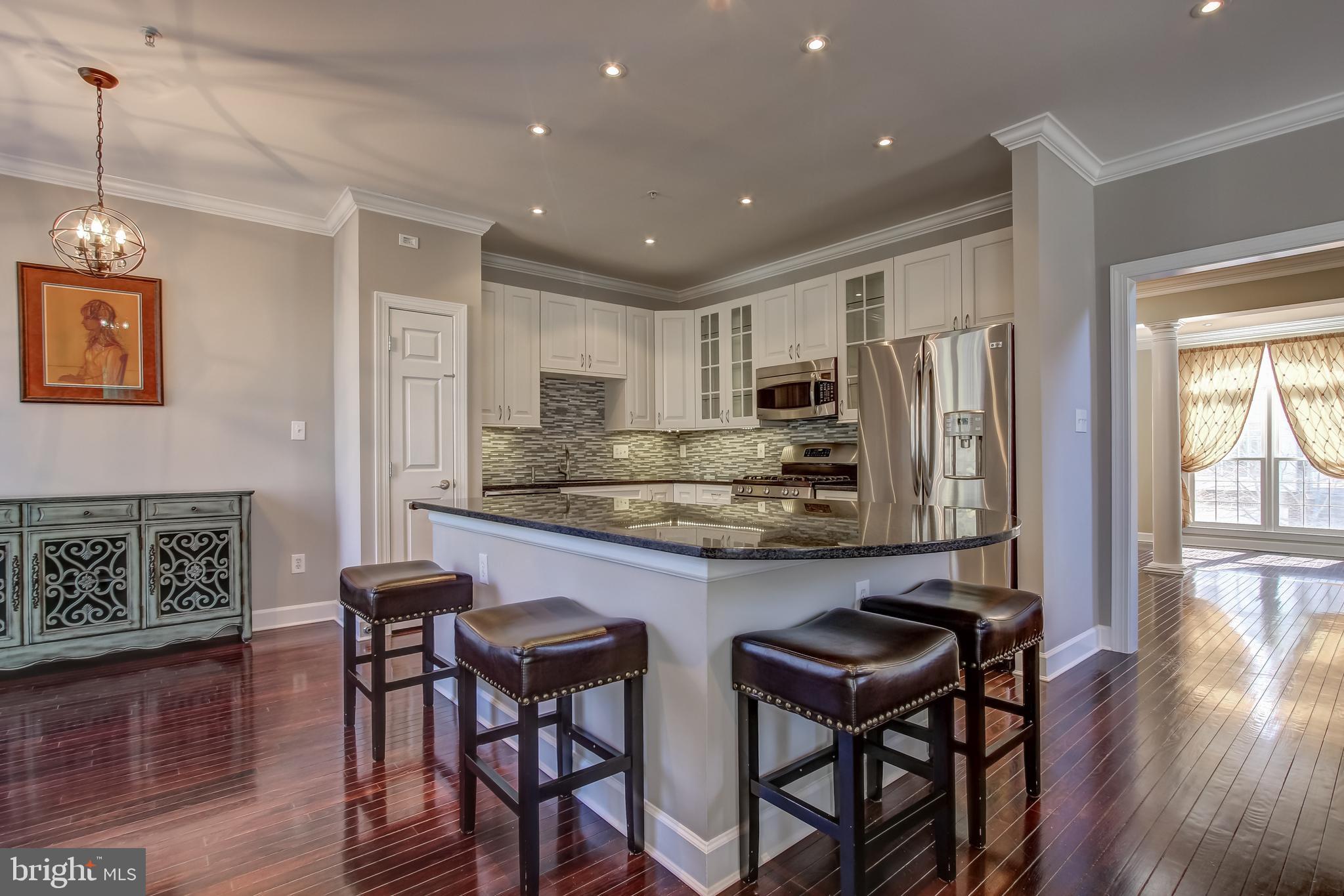 8445 Bells Ridge Terrace Potomac, MD 20854 - Photo 8 of 30 Kitchen With Island And Seating For Four