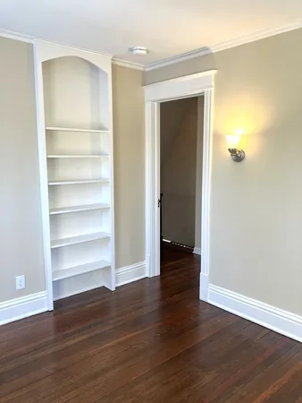 a view of a room with wooden floor