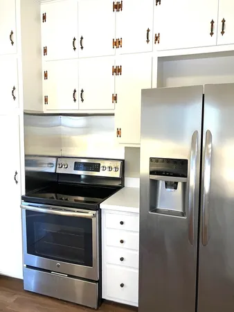 a stove top oven sitting inside of a kitchen