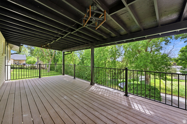 871 Bonita Way Centerville, UT 84014 - Photo 20 of 61 Expansive covered deck featuring wood-finish flooring, black metal railings, and an exposed beam ceiling
