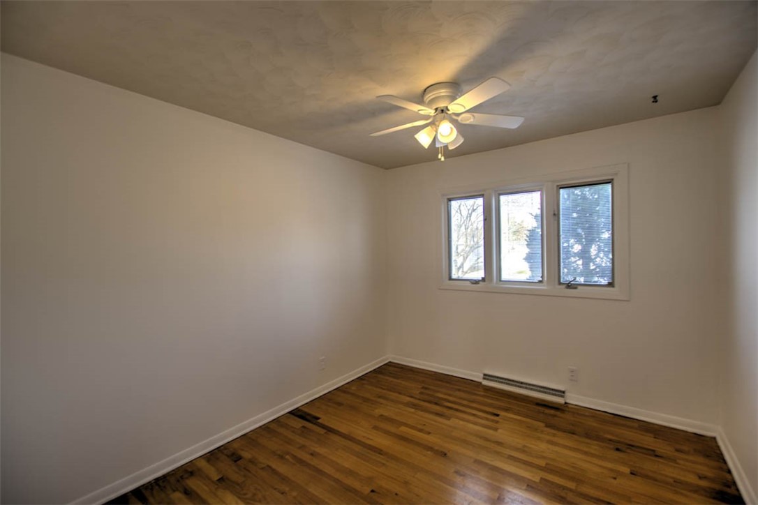155 Columbus Drive Decatur, IL 62526 - Photo 15 of 30 a view of empty room with wooden floor and fan