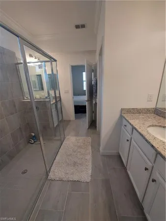 a bathroom with a granite countertop sink a toilet and vanity