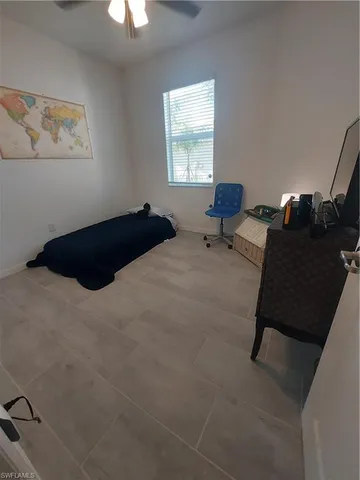 a kitchen with a sink a refrigerator and chairs