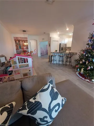 a living room with lots of furniture and a chandelier