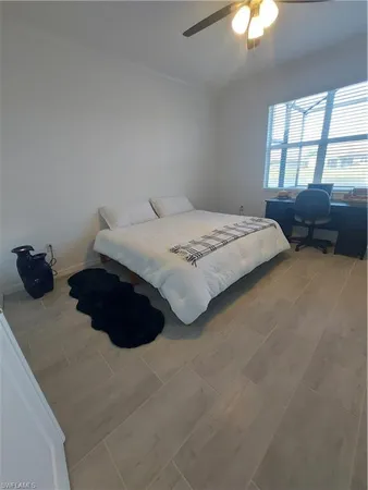 a bedroom with a bed a lamp and a chandelier