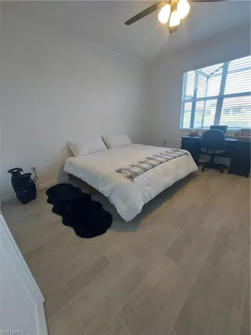 a bedroom with a bed a lamp and a chandelier