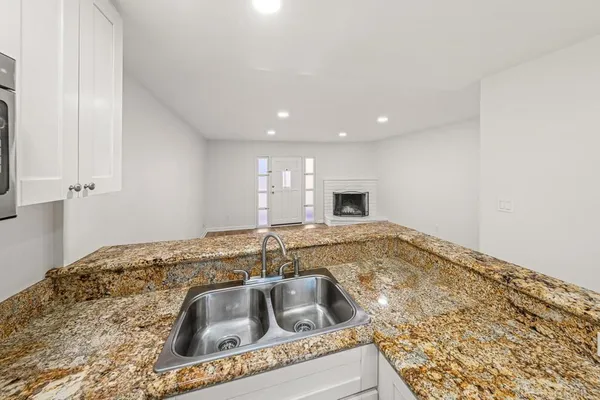 a kitchen with a sink and a granite top