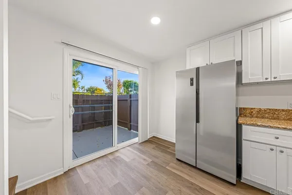 a kitchen with stainless steel appliances granite countertop a refrigerator and a sink