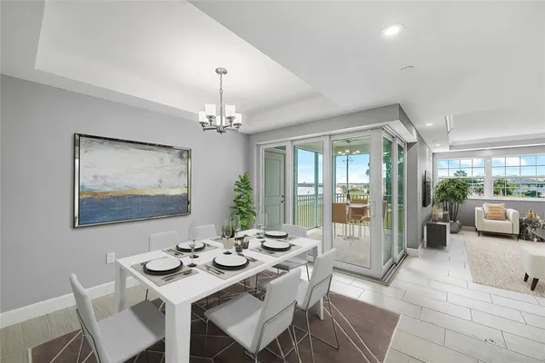 a view of a dining room with furniture wooden floor and chandelier