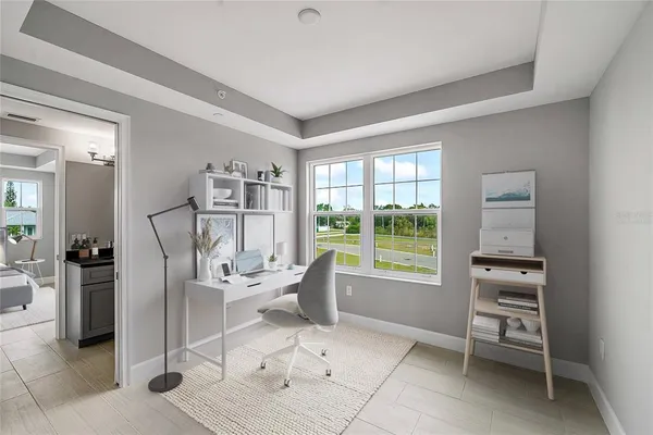 a dining room with furniture and a floor to ceiling window
