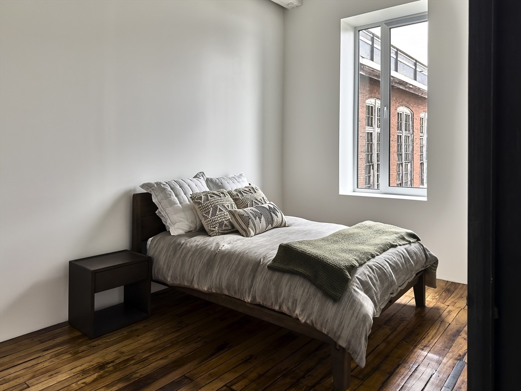 520 State Road, Unit 205 North Adams, MA 01247 - Photo 13 of 20 a bedroom with a bed and wooden floor