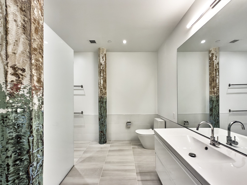 520 State Road, Unit 205 North Adams, MA 01247 - Photo 15 of 20 a bathroom with a double vanity sink and mirror