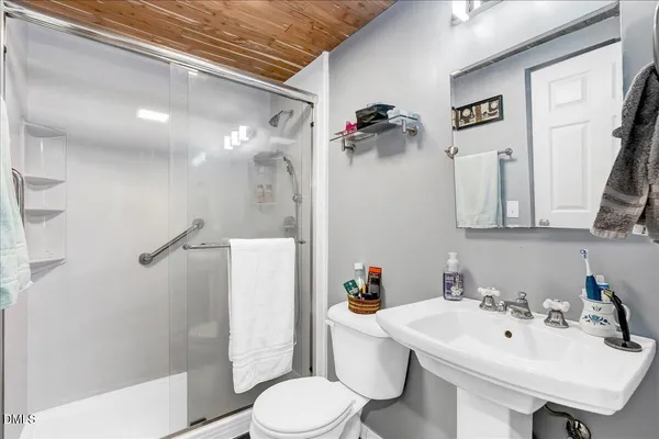 a bathroom with a sink toilet and shower