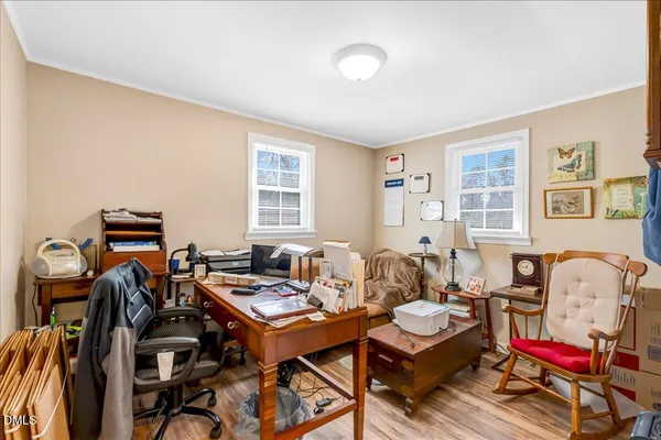a living room with furniture a flat screen tv and a window
