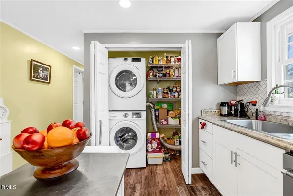 a utility room with sink dryer and washer