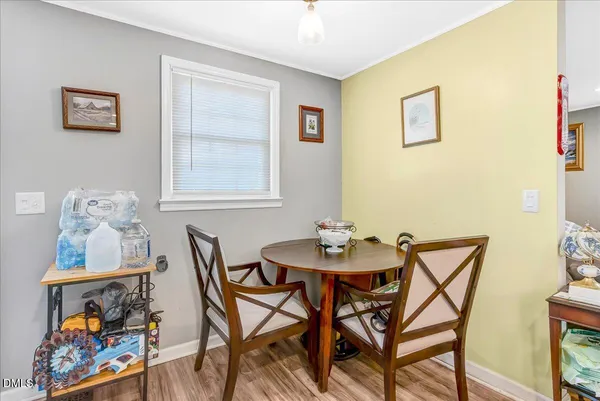 a view of a dining room with furniture and a potted plant