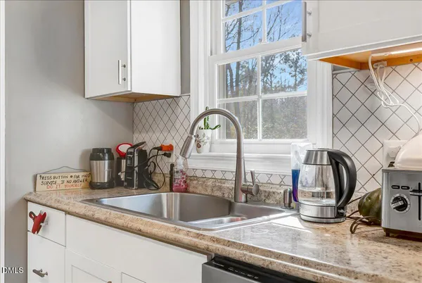 a kitchen with a sink and a stove next to a window