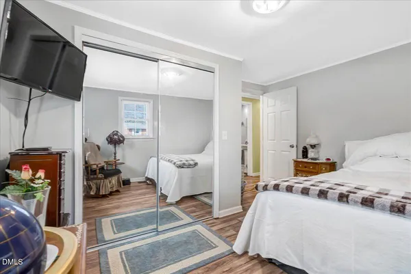 a bedroom with furniture and a flat screen tv