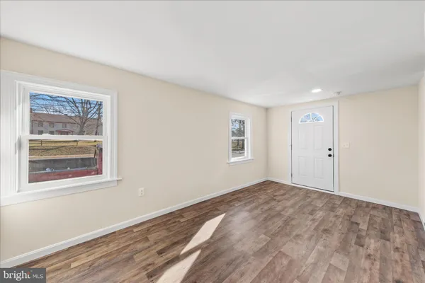 a view of a room with wooden floor