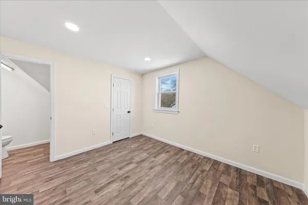 a large kitchen with a lot of counter space and wooden floor