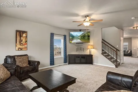a living room with furniture and a chandelier