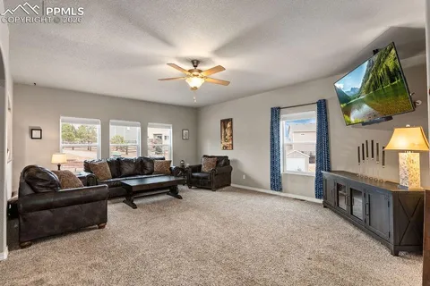 a living room with furniture fireplace and a window