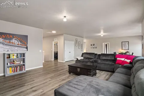 a living room with furniture and wooden floor