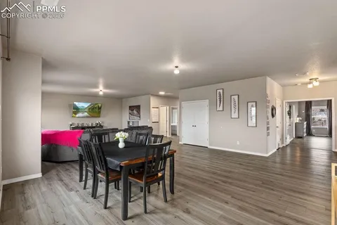 a view of a dining room with furniture and wooden floor