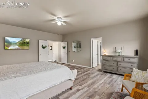 a bedroom with a bed and ceiling fan
