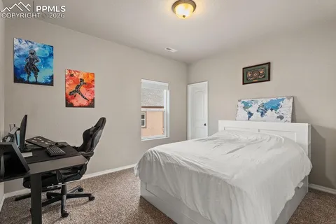 a bedroom with a bed and a desk