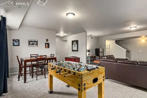 a living room with stainless steel appliances kitchen island granite countertop furniture and a view of kitchen