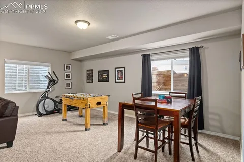a dining room with furniture and window