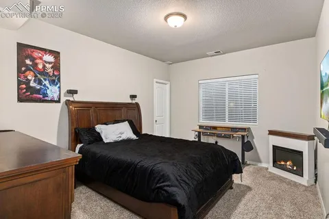 a bedroom with a bed and a fireplace