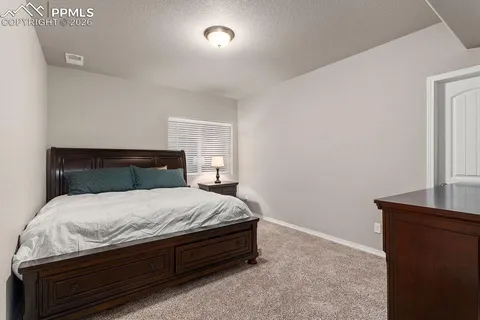 a bedroom with a bed and a night stand