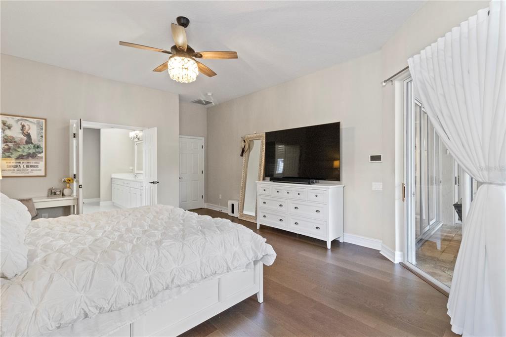 11208 Ledgement Lane Windermere, FL 34786 - Photo 11 of 36 a bedroom with a bed and a flat tv screen on dresser