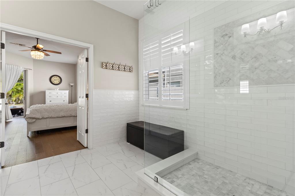 11208 Ledgement Lane Windermere, FL 34786 - Photo 15 of 36 a bedroom with a bed and a chandelier