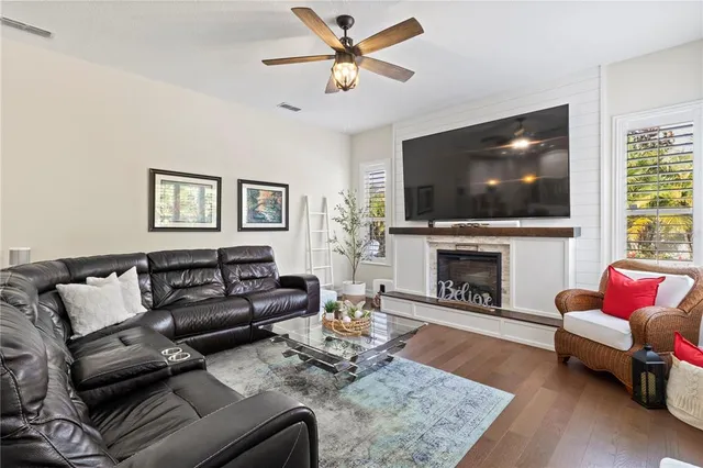a living room with furniture a flat screen tv and a fireplace