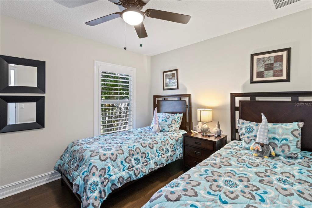 11208 Ledgement Lane Windermere, FL 34786 - Photo 25 of 36 a bedroom with two beds and a chandelier
