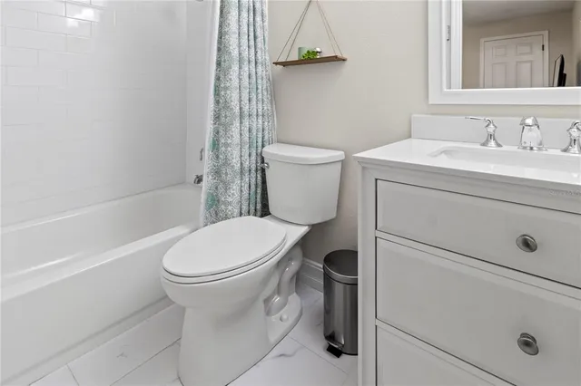 a bathroom with a toilet sink and shower
